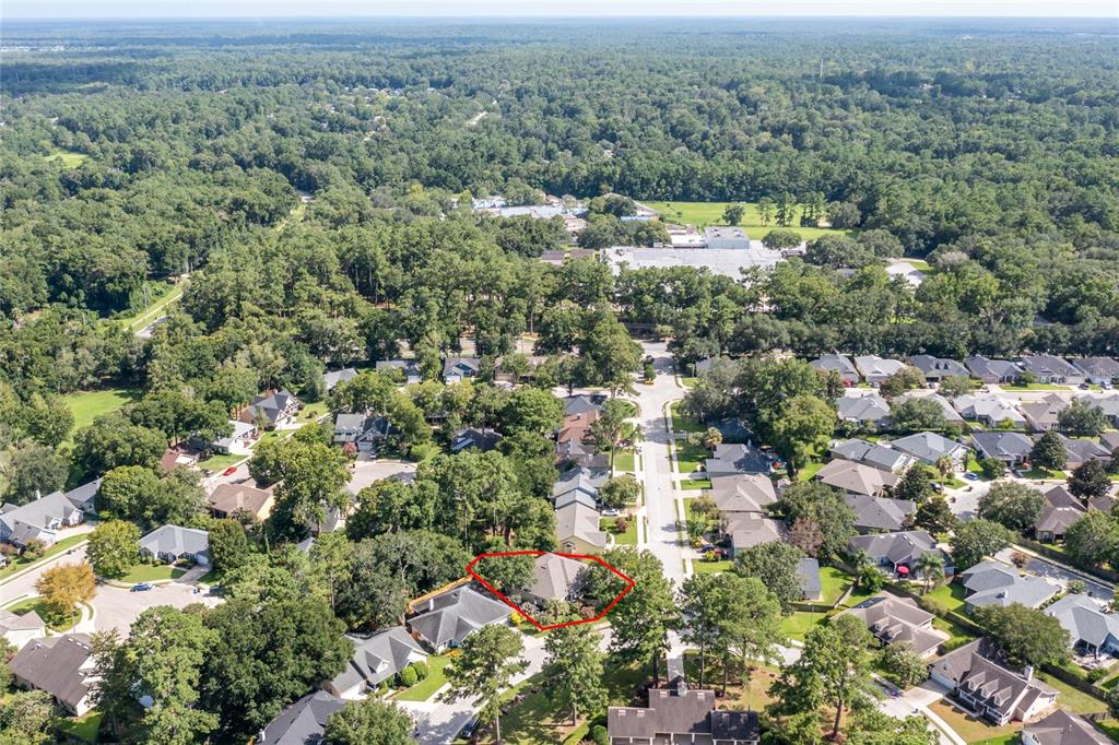 An aerial view shows a residential neighborhood with a single-family home outlined in red — 2429 NW 93RD STREET, GAINESVILLE, FL