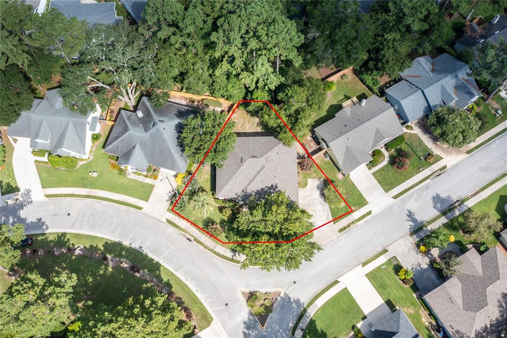 An aerial view shows a single-family home on a corner lot with a red outline — 2429 NW 93RD STREET, GAINESVILLE, FL