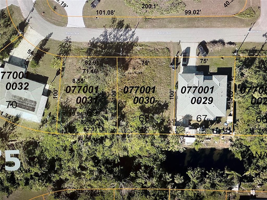 This is a satellite map showing residential property lot lines and parcel numbers — LOT 69 MANATI AVENUE, NORTH PORT, FL