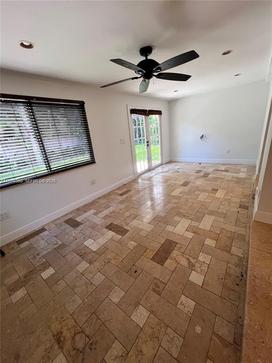 A room with a ceiling fan, tiled floor, window blinds, and glass doors leading outside — 7350 SW 96th St # 7350, Pinecrest FL 33156, PINECREST, FL