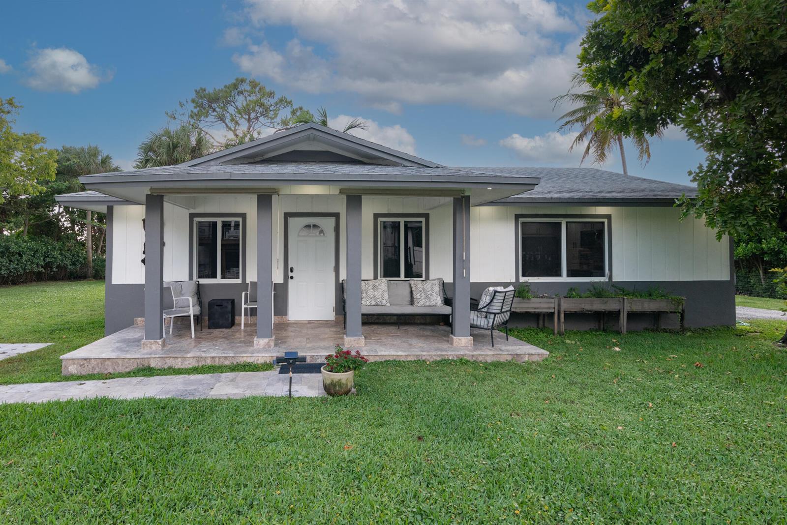 A single-story house with a covered front porch, white siding, and gray trim — 13487 Barwick Road # B, Delray Beach FL 33445, DELRAY BEACH, FL