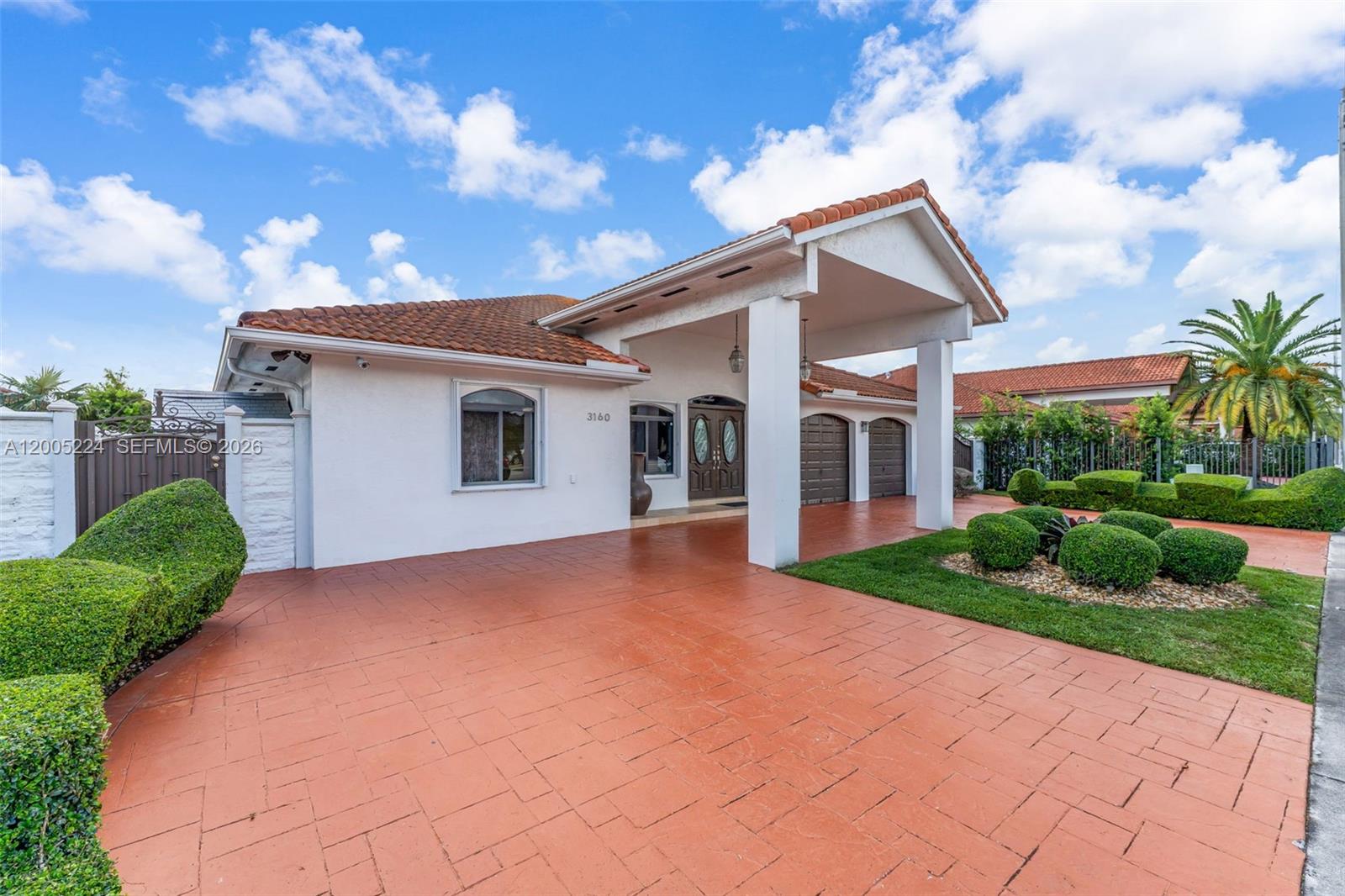 A single-story house with a terracotta tile roof, white stucco walls, and a paved driveway — 3160 SW 142nd Ave, Miami FL 33175, MIAMI, FL