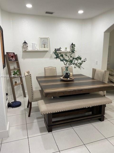 A dining room features a square wooden table, upholstered chairs, a bench, and wall shelves — 18214 SW 144th Pl, Miami FL 33177, MIAMI, FL