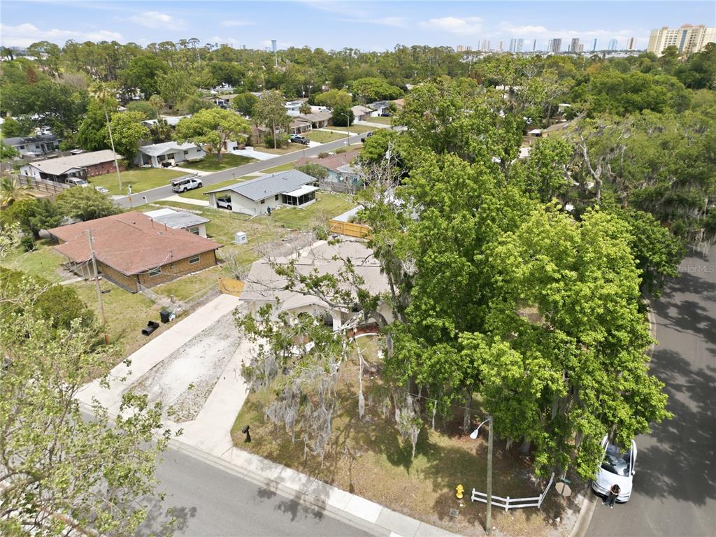 An aerial view shows a residential neighborhood with houses, trees, and a street corner — 2861 W OAK LEA DRIVE, SOUTH DAYTONA, FL