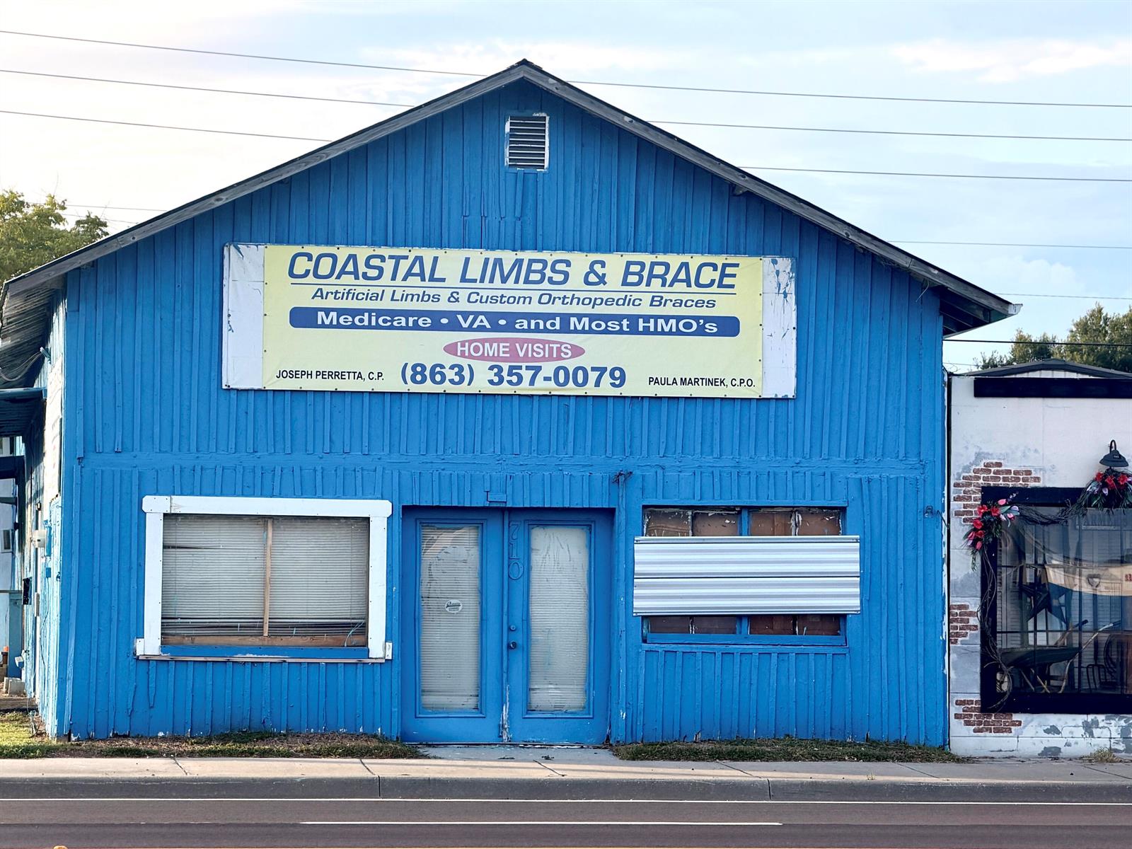 The exterior of a blue building with a sign for Coastal Limbs & Brace — 710 NW Park Street, Okeechobee FL 34972, OKEECHOBEE, FL
