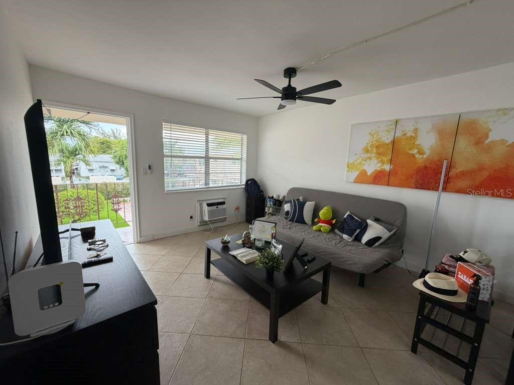 A living room features tile floors, a ceiling fan, a sofa, and a glass door — 1710 MCKINLEY STREET UNIT 16, HOLLYWOOD, FL