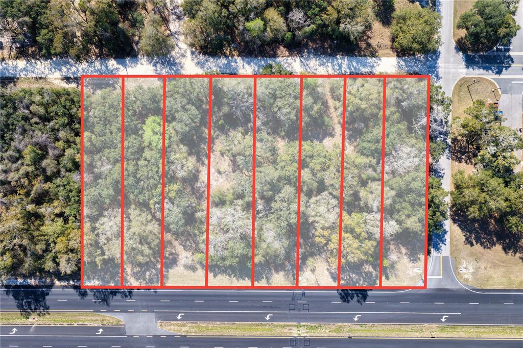 An aerial view shows a rectangular plot of land divided into eight adjacent lots — TBD 000 NW US HWY 19 N, CHIEFLAND, FL