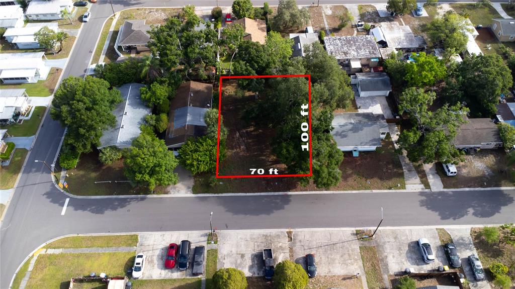 An aerial view shows a vacant rectangular lot outlined in red between two residential houses — 1310 BROWNING STREET, CLEARWATER, FL