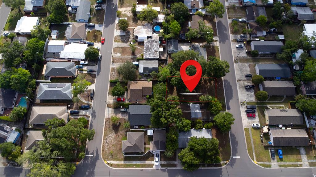 An aerial view shows a vacant residential lot marked with a red pin — 1310 BROWNING STREET, CLEARWATER, FL