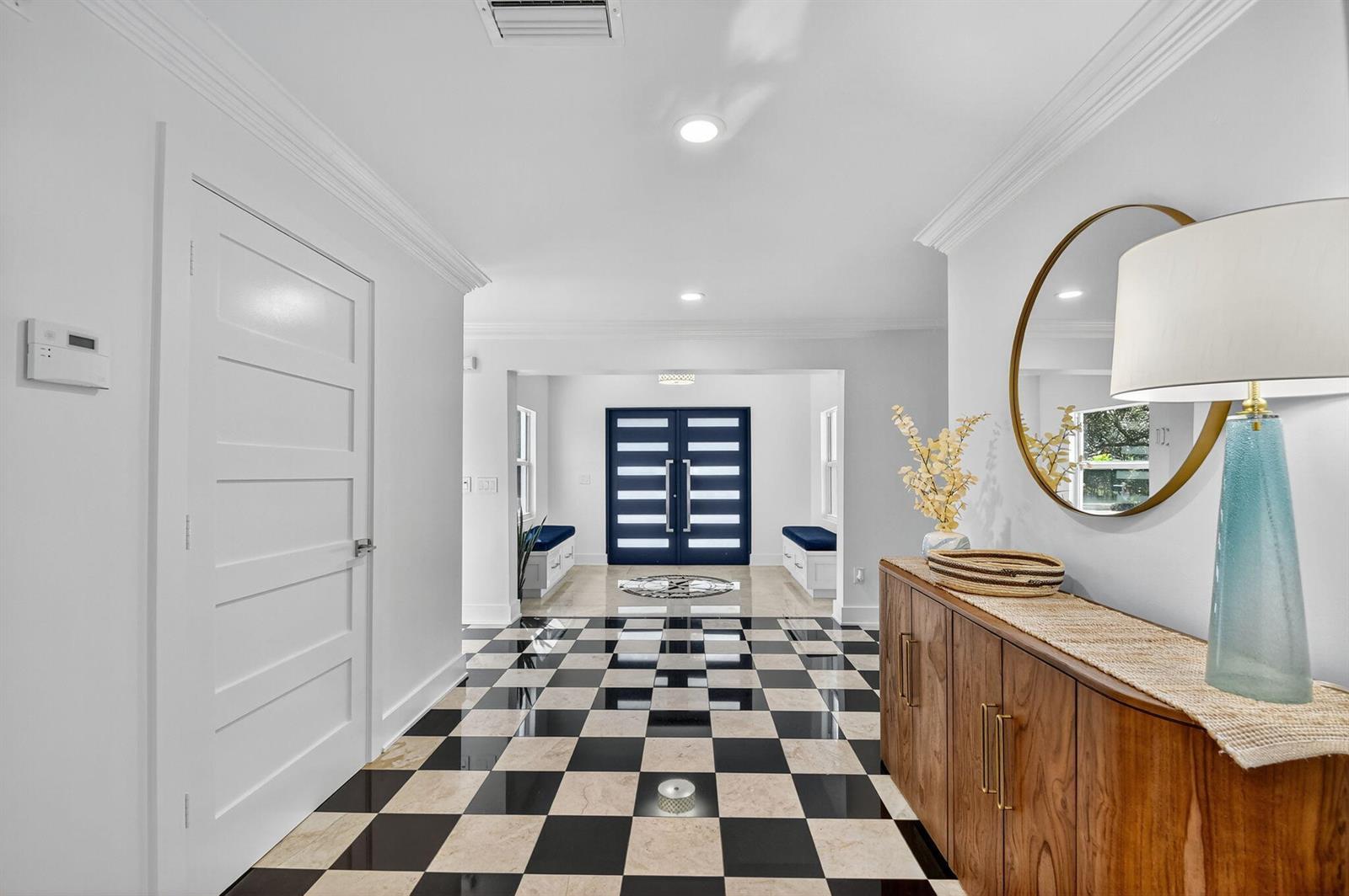 A foyer features a black and white checkered floor, a wooden console, and blue doors — 2900 Greenbriar Boulevard, Wellington FL 33414, WELLINGTON, FL