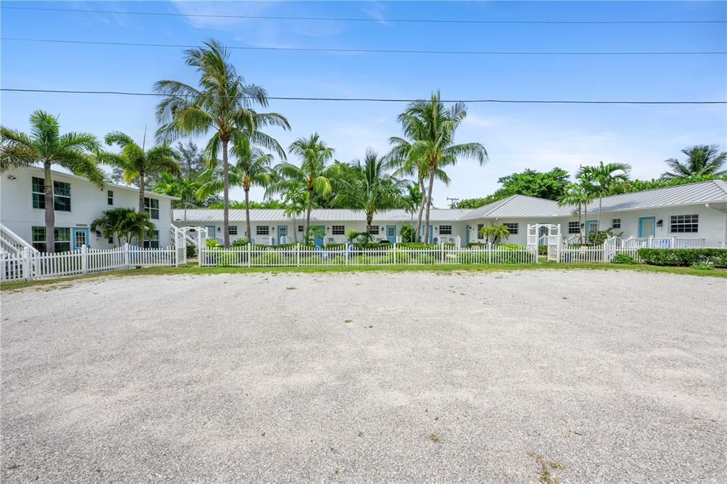 A gravel parking lot sits in front of a white, single-story coastal apartment complex — 2502 TAMARIND DRIVE, FORT PIERCE, FL