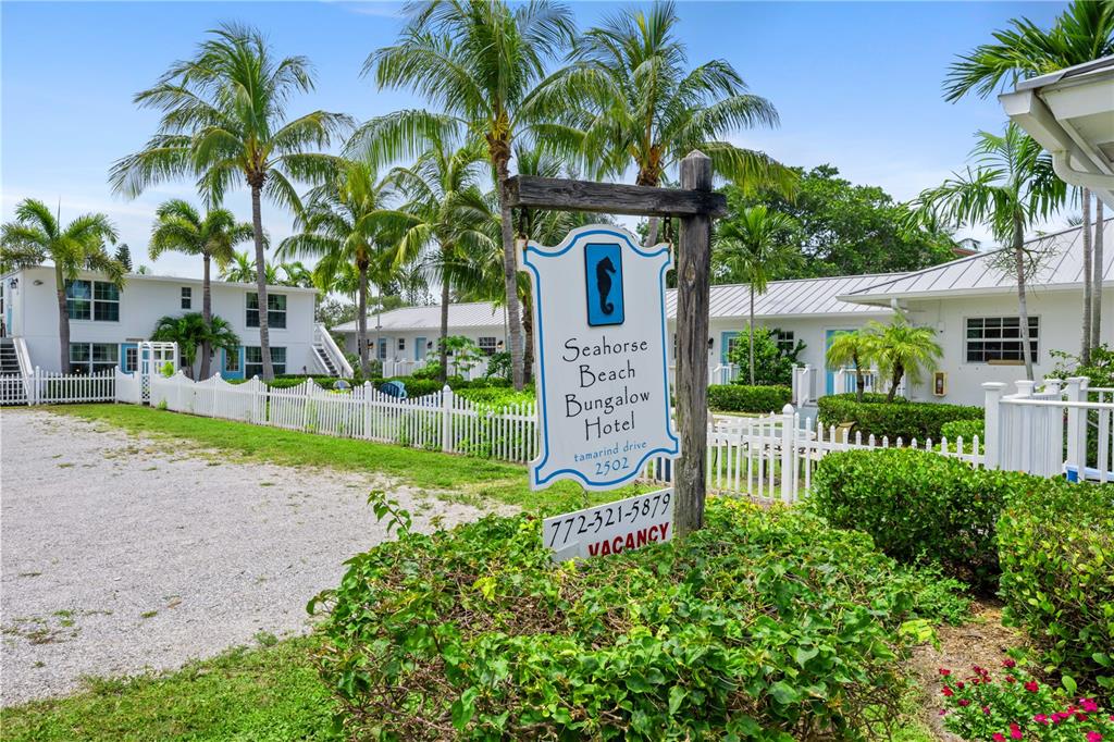 A sign for the Seahorse Beach Bungalow Hotel stands before white buildings and palm trees — 2502 TAMARIND DRIVE, FORT PIERCE, FL