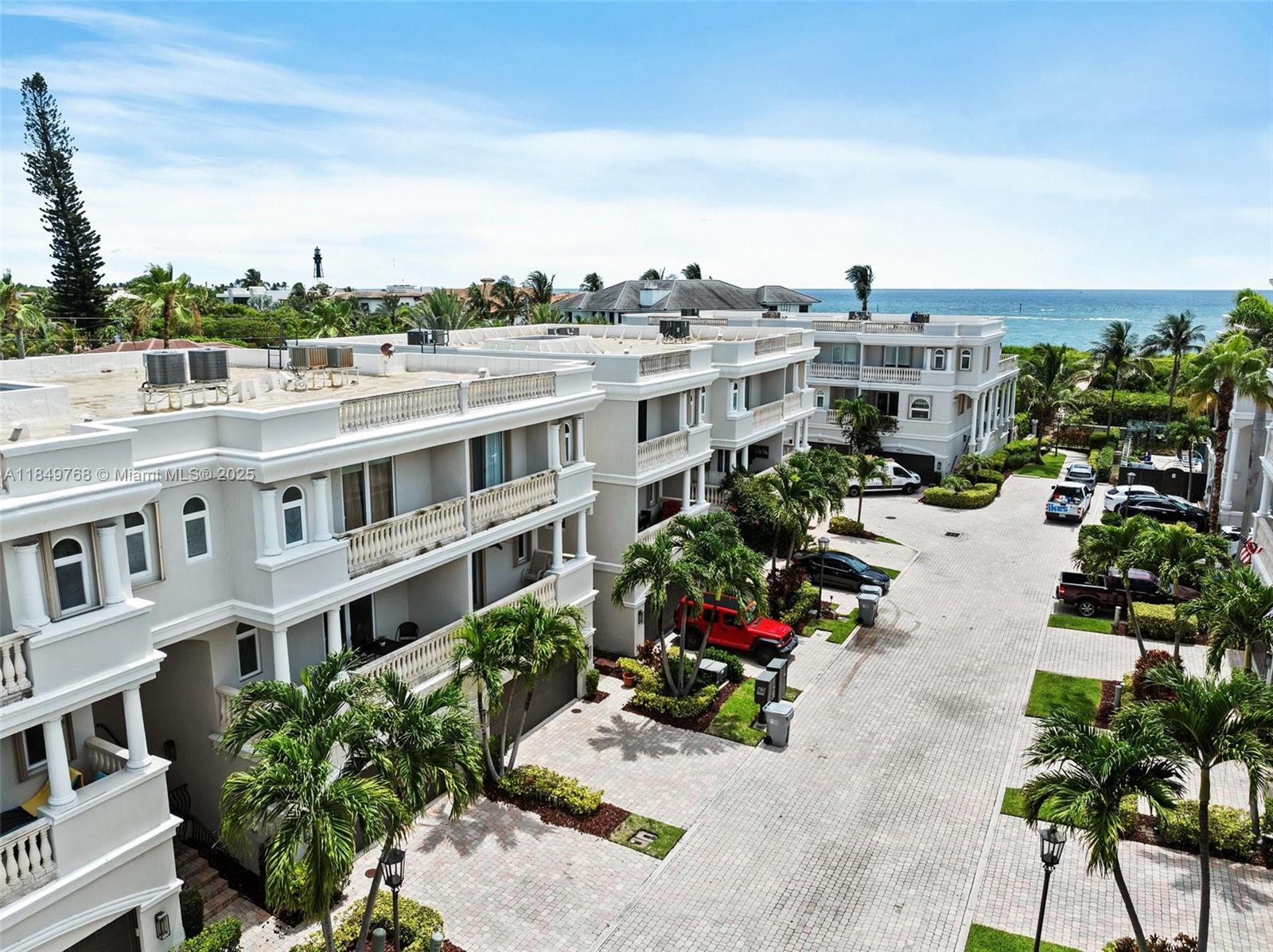 An aerial view shows a multi-story residential complex with paved driveways and palm trees — 1784 Bay Dr # 1784, Pompano Beach FL 33062, POMPANO BEACH, FL