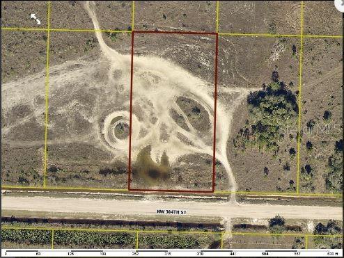This aerial map shows a rectangular plot of land with dirt tracks and a small pond — 17167 NW 304TH STREET, OKEECHOBEE, FL