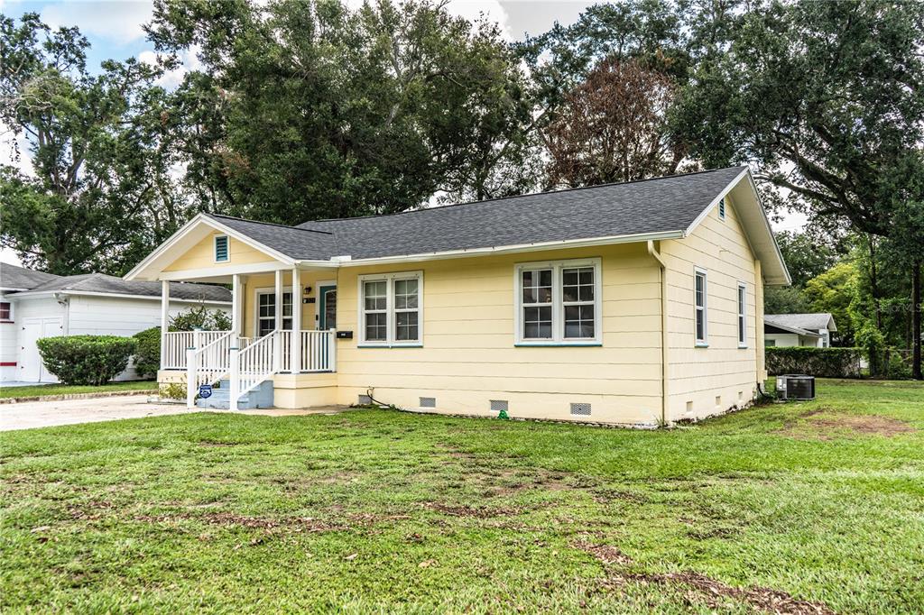 A yellow single-story house with a front porch and a dark shingled roof — 528 S INGRAHAM AVENUE, LAKELAND, FL