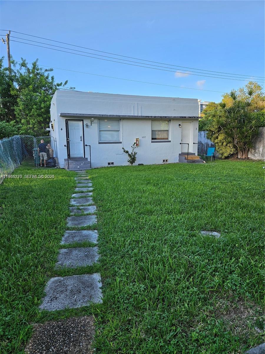 A single-story white stucco duplex with two front doors and a stone walkway — 1437 NE 110th Ter # 4, Miami FL 33161, MIAMI, FL