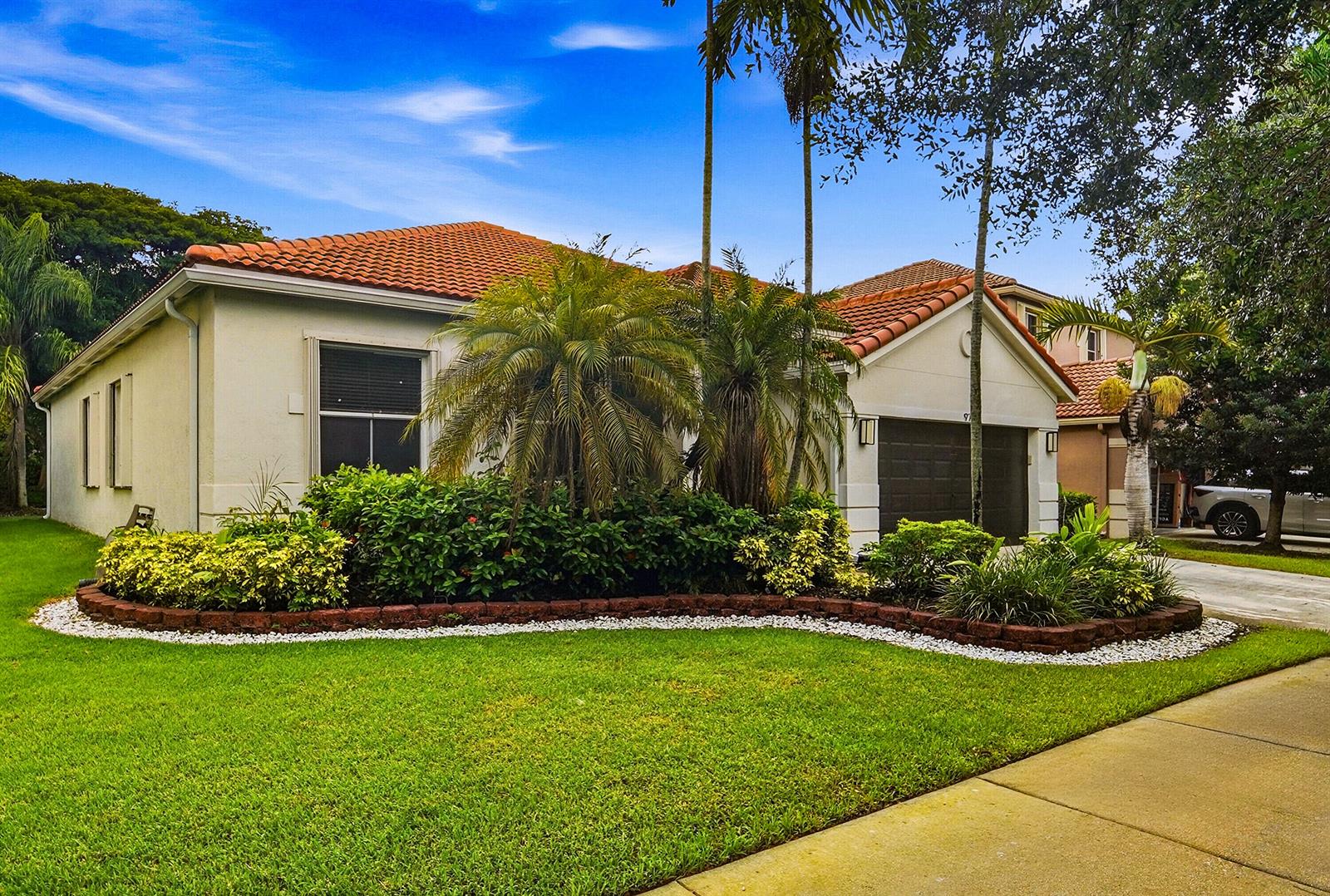 A single-story house with a tile roof, garage, and landscaped front yard — 970 Tulip Circle, Weston FL 33327, WESTON, FL