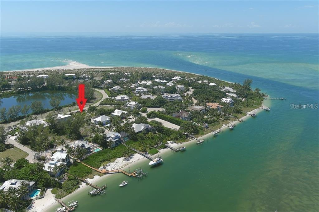 An aerial view shows a coastal residential area with a red arrow pointing to a lot — 16080 GULF SHORES DRIVE, BOCA GRANDE, FL
