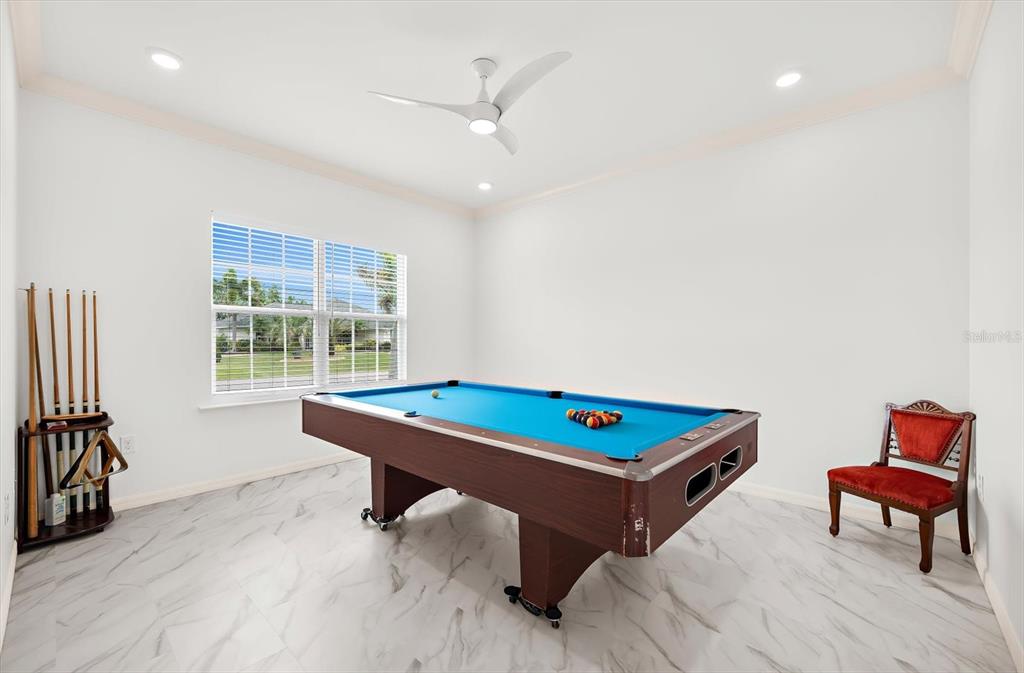 A game room features a blue pool table, a cue rack, and a red chair — 2365 MAURITANIA ROAD, PUNTA GORDA, FL