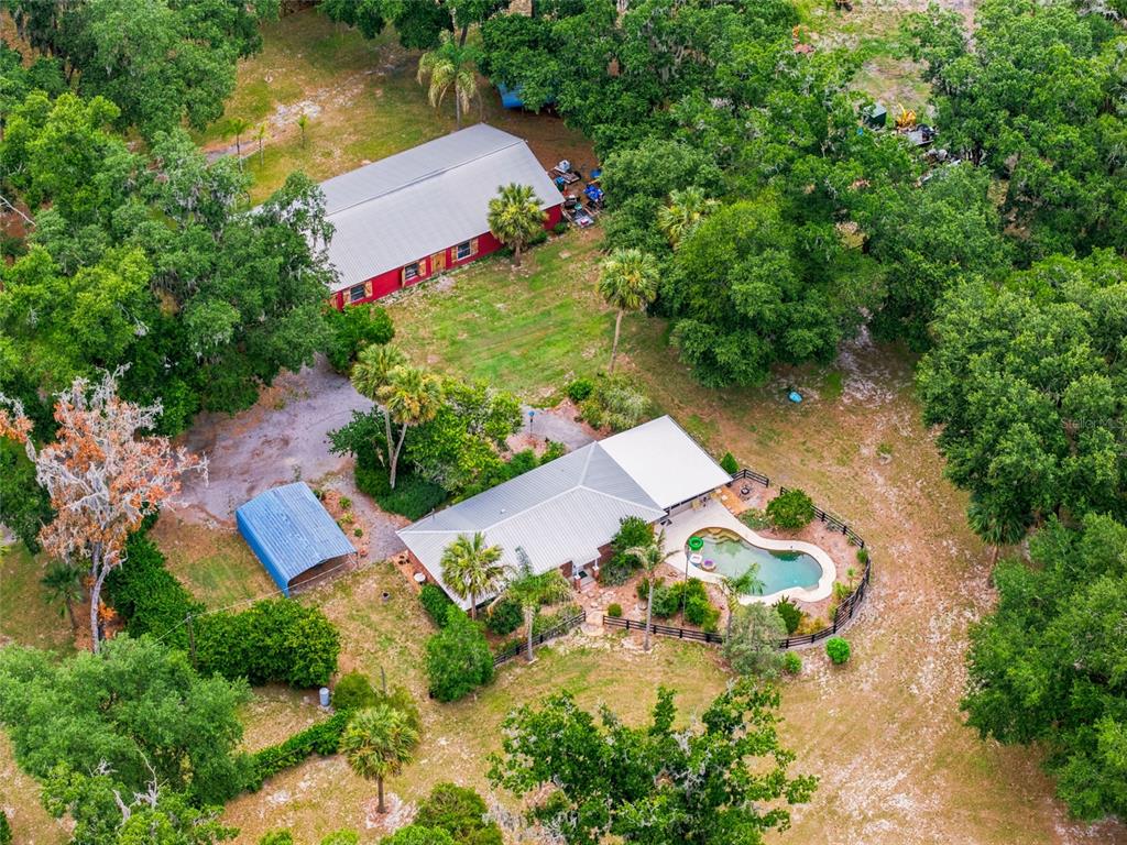 An aerial view shows a house with a pool, a red barn, and a metal carport — 40847 COUNTY ROAD 439, UMATILLA, FL