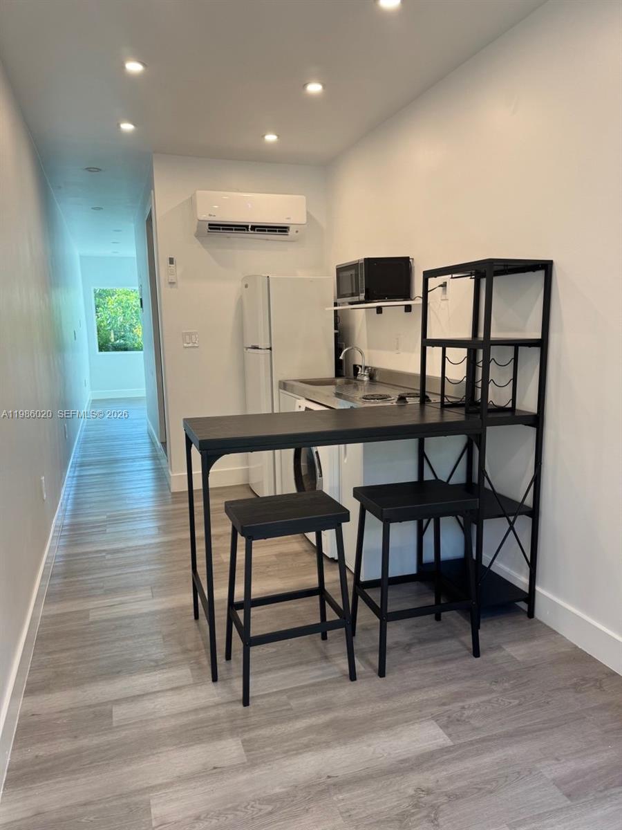 A small kitchenette features a black bar table with stools and a white refrigerator — 5800 SW 122nd Ave # 2, Miami FL 33183, MIAMI, FL