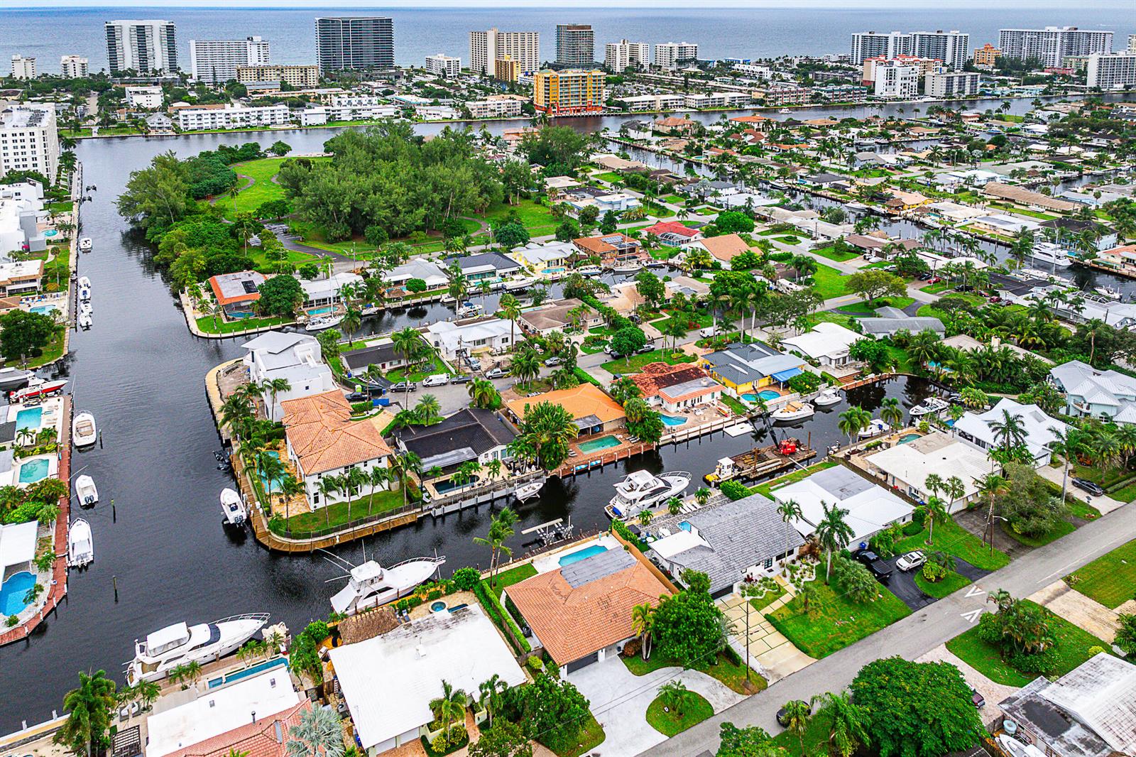 An aerial view of waterfront residential homes with private boat docks along a canal — 1250 NE 27th Terrace, Pompano Beach FL 33062, POMPANO BEACH, FL