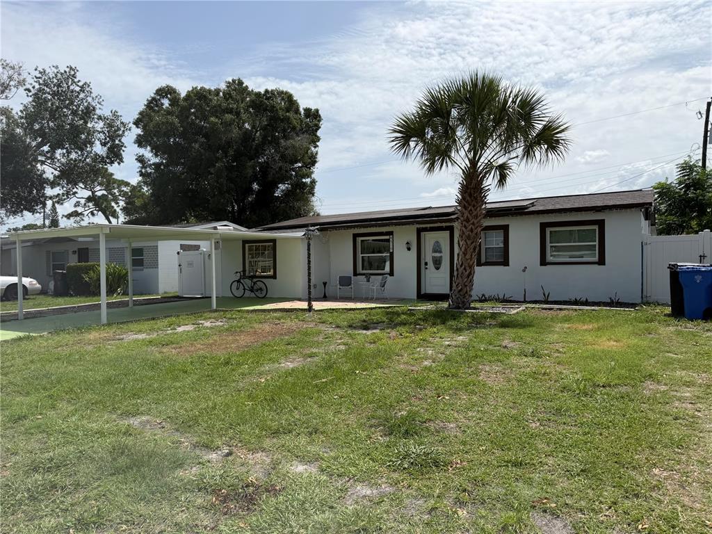 A single-story house with a carport, a palm tree, and a grassy front yard — 4519 EDEN ROCK ROAD, TAMPA, FL