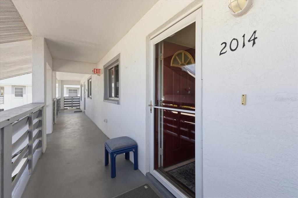 An exterior walkway leads to a front door marked with the number 2014 — 6800 PLACIDA ROAD UNIT 2014, ENGLEWOOD, FL