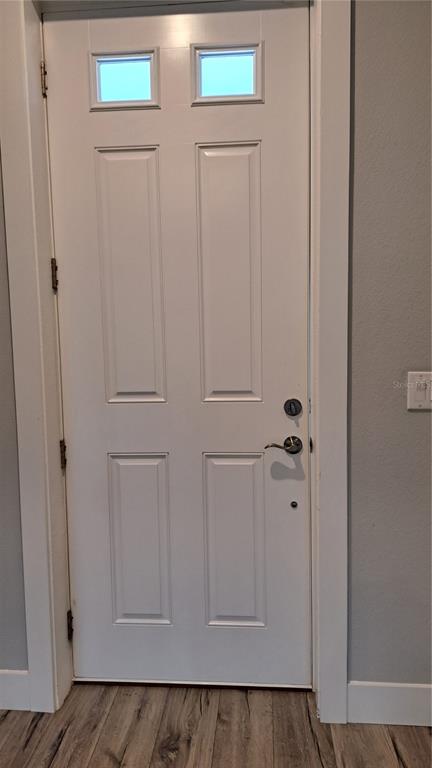 A white four-panel door with two top windows and a handle set — 52 ETHAN ALLEN DRIVE, PALM COAST, FL