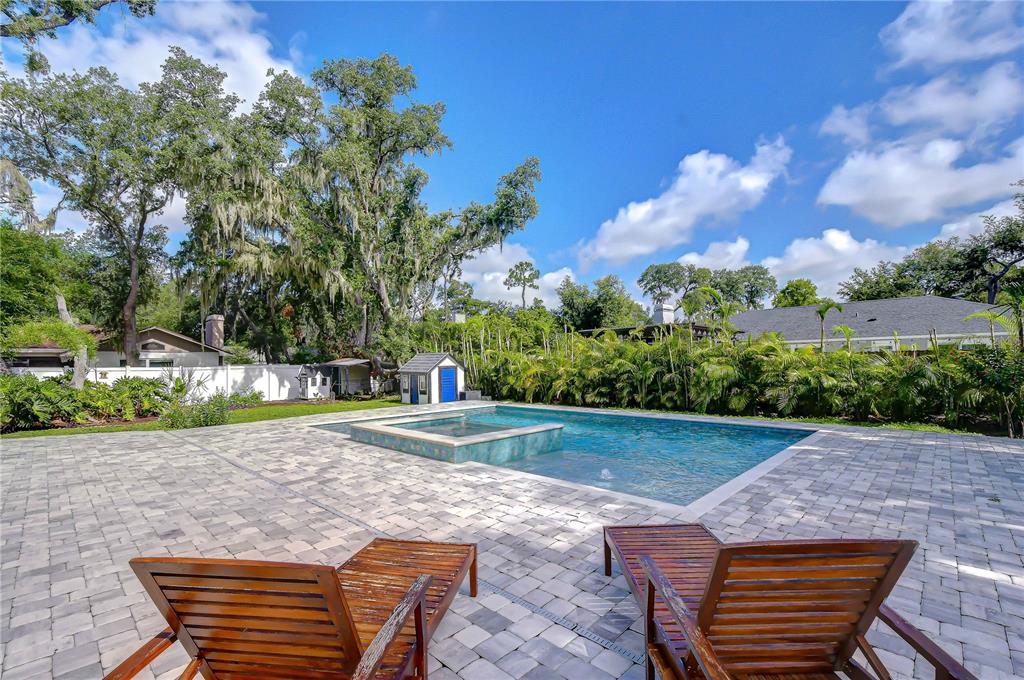 A two-story white house with a black garage door and a stone walkway — 106 BAYFIELD DRIVE, BRANDON, FL
