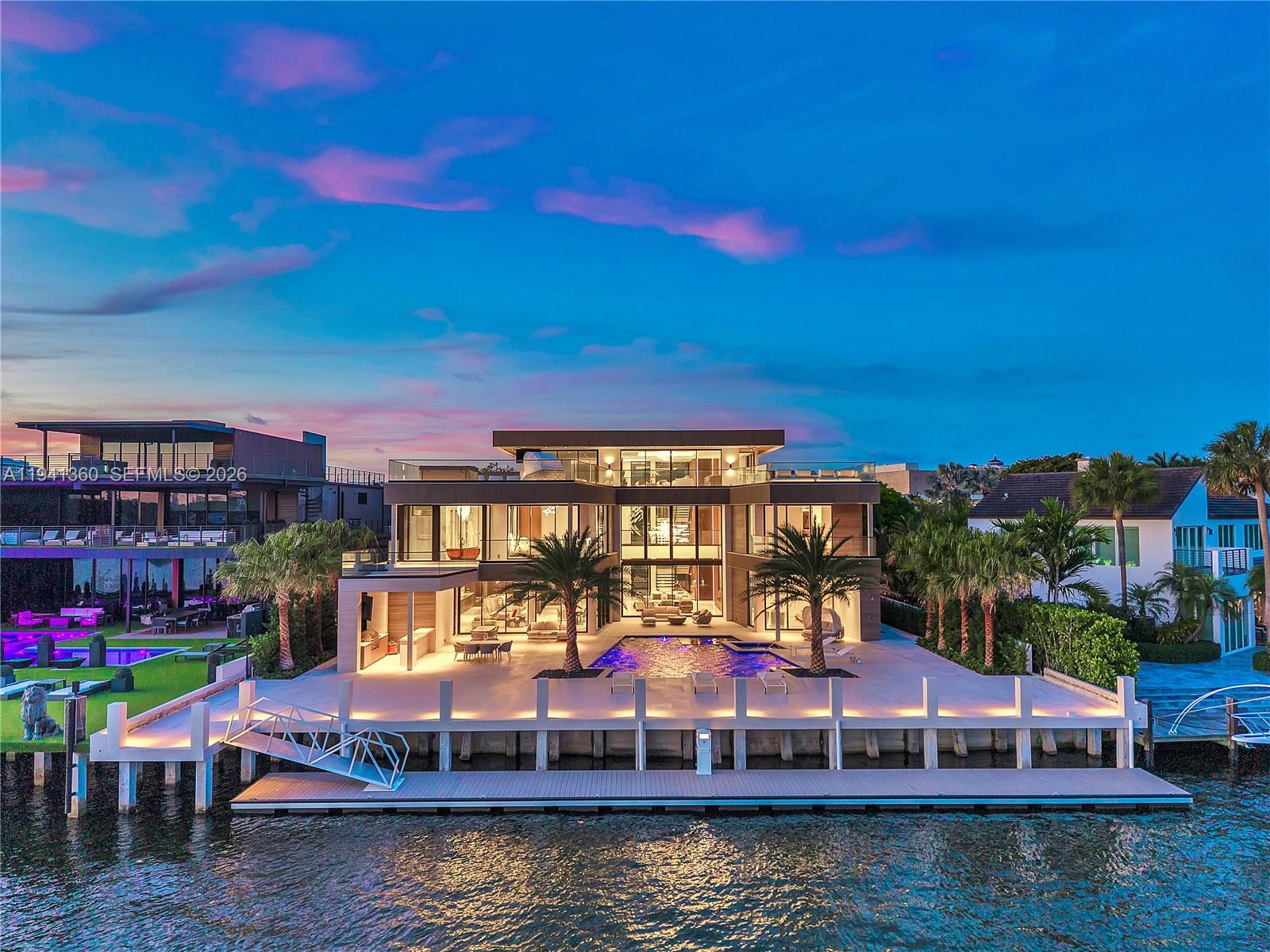 A modern three-story waterfront mansion features a swimming pool, palm trees, and a private dock — 725 Middle River Dr, Fort Lauderdale FL 33304, FORT LAUDERDALE, FL