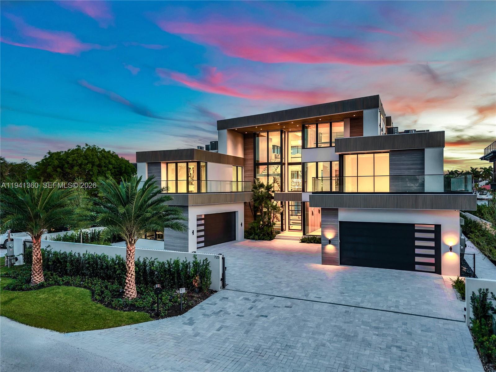 A modern three-story luxury home features a paved driveway, two garages, and large glass windows — 725 Middle River Dr, Fort Lauderdale FL 33304, FORT LAUDERDALE, FL