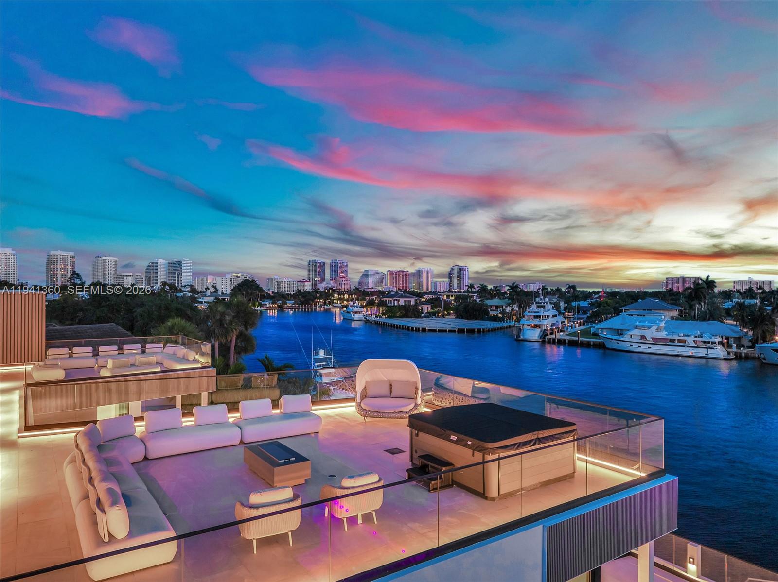 A rooftop terrace features white lounge seating, a hot tub, and views of a waterway — 725 Middle River Dr, Fort Lauderdale FL 33304, FORT LAUDERDALE, FL
