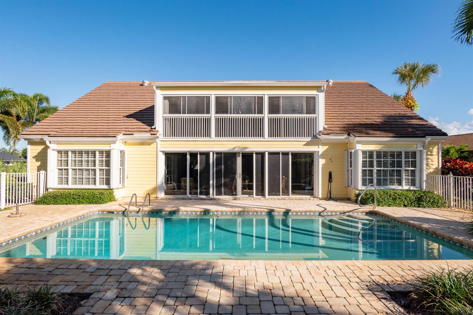 An aerial view of a yellow house with a brown roof and palm trees — 3360 SE Golf Trail, Stuart FL 34997, STUART, FL