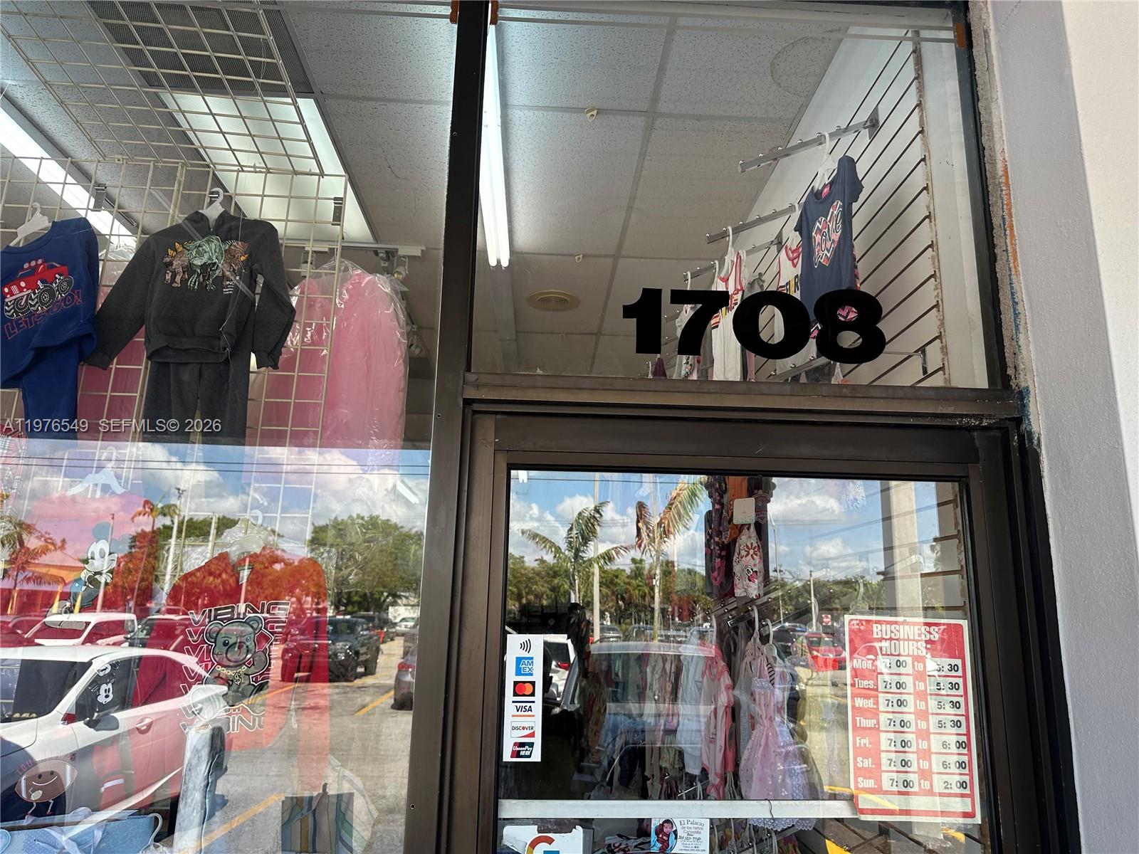 The exterior view shows a storefront window displaying children's clothing with business hours posted — 1708 W 68 Street, Hialeah FL 33014, HIALEAH, FL
