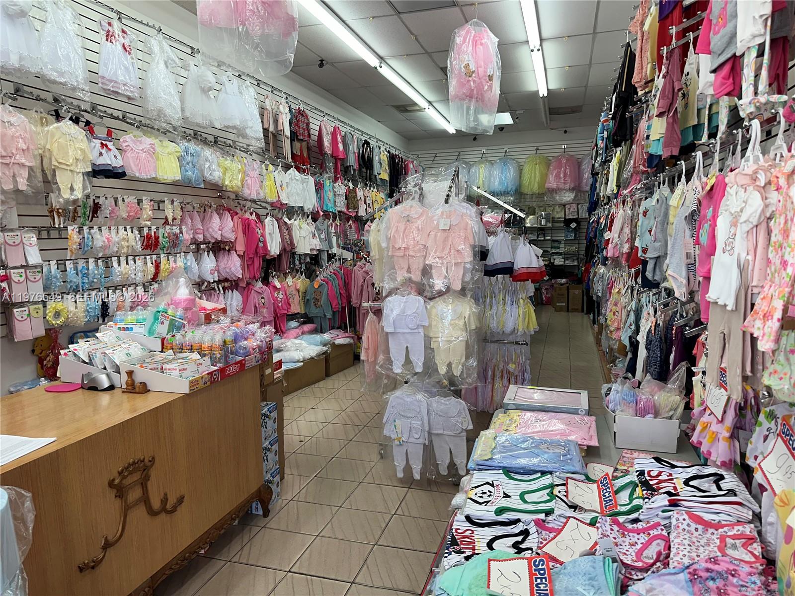 A retail store interior features racks and walls filled with infant clothing and baby supplies — 1708 W 68 Street, Hialeah FL 33014, HIALEAH, FL