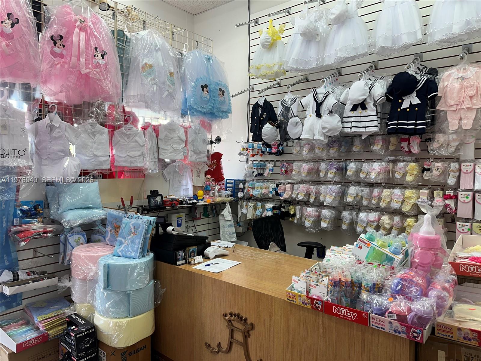 A retail store interior features walls lined with baby clothing, accessories, and merchandise displays — 1708 W 68 Street, Hialeah FL 33014, HIALEAH, FL