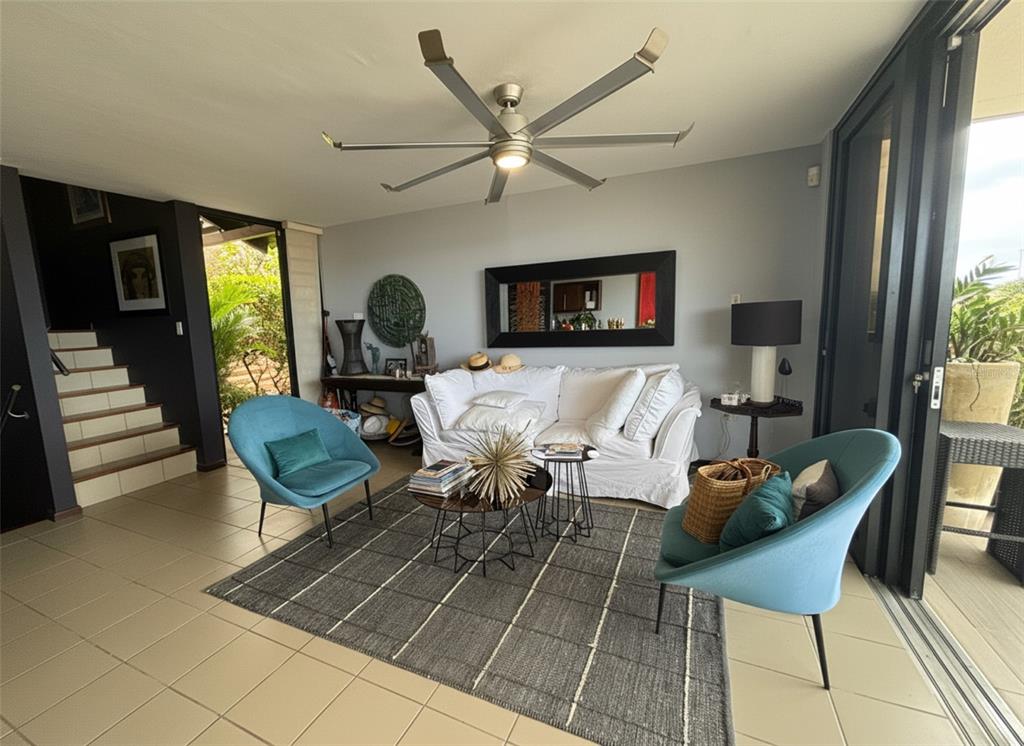 A living room features a white sofa, two blue chairs, a rug, and a ceiling fan — 170 PALMAS  DRIVE DRIVE UNIT B14, HUMACAO, PR