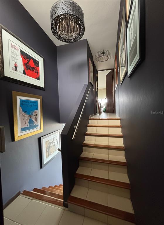 A staircase with tiled steps and wooden edges leads upward between dark-painted walls — 170 PALMAS  DRIVE DRIVE UNIT B14, HUMACAO, PR