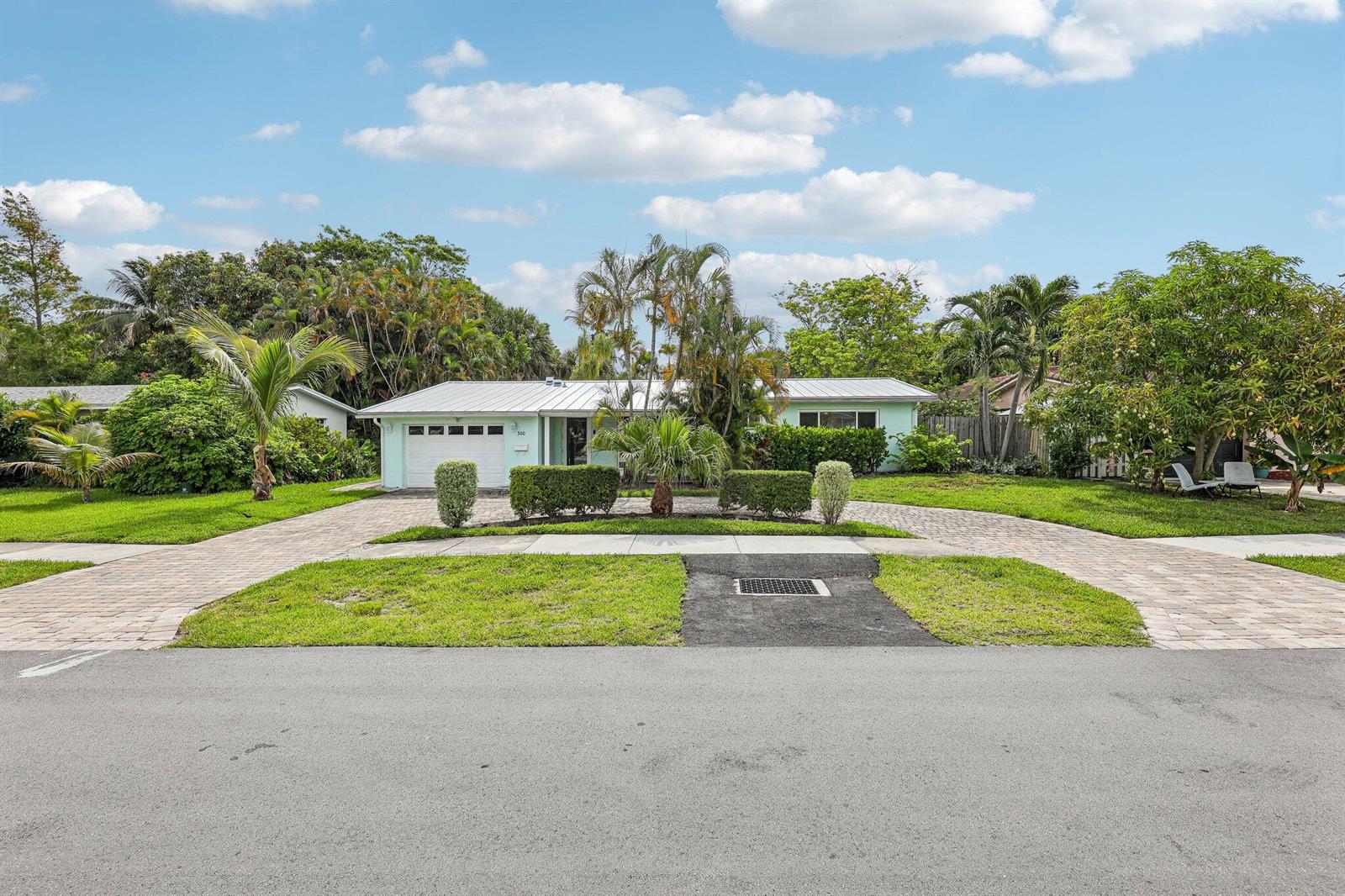 A light green, single-story house with a metal roof and a circular paved driveway — 500 SE 8th Avenue, Deerfield Beach FL 33441, DEERFIELD BEACH, FL