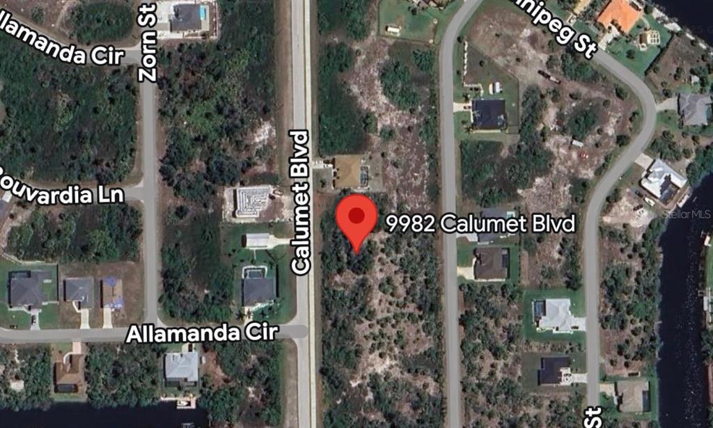 This is a satellite map view showing a vacant lot marked with a red pin — 9982 CALUMET BOULEVARD, PORT CHARLOTTE, FL