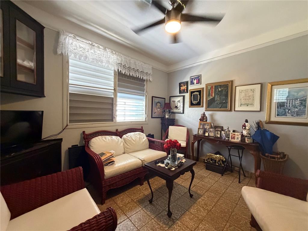 A living room features wicker furniture, a ceiling fan, tiled floors, and a gallery wall — 559 CALLE AUSTRAL, SAN JUAN, PR