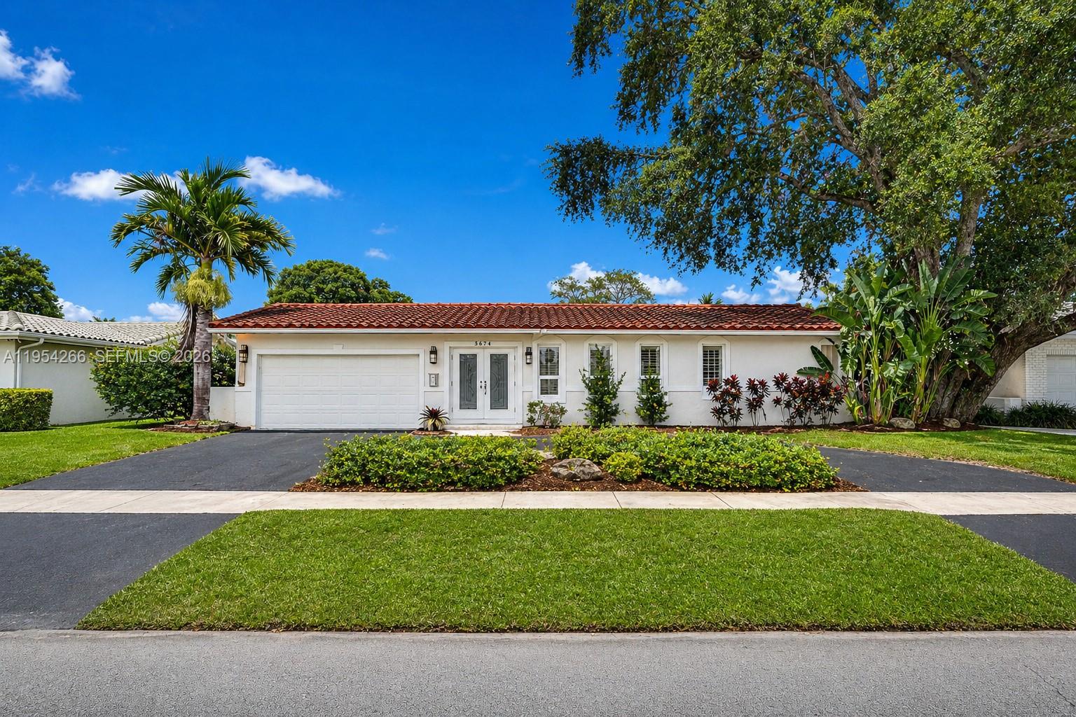 A single-story house with a white exterior, red tile roof, and a two-car garage — 3671 N 47th Ave, Hollywood FL 33021, HOLLYWOOD, FL
