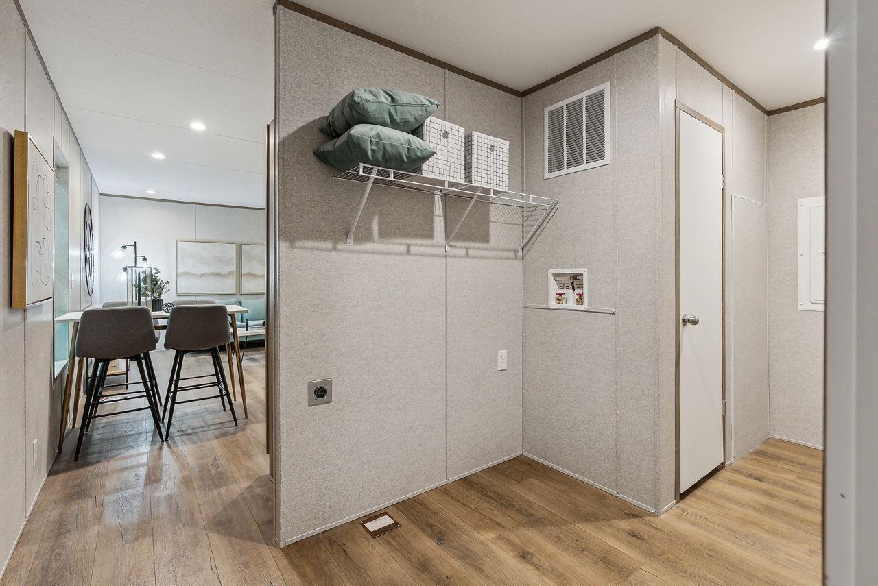 A laundry room with a wire shelf, utility hookups, and wood-look flooring — 820 Maryland Avenue, Clewiston FL 33440, CLEWISTON, FL