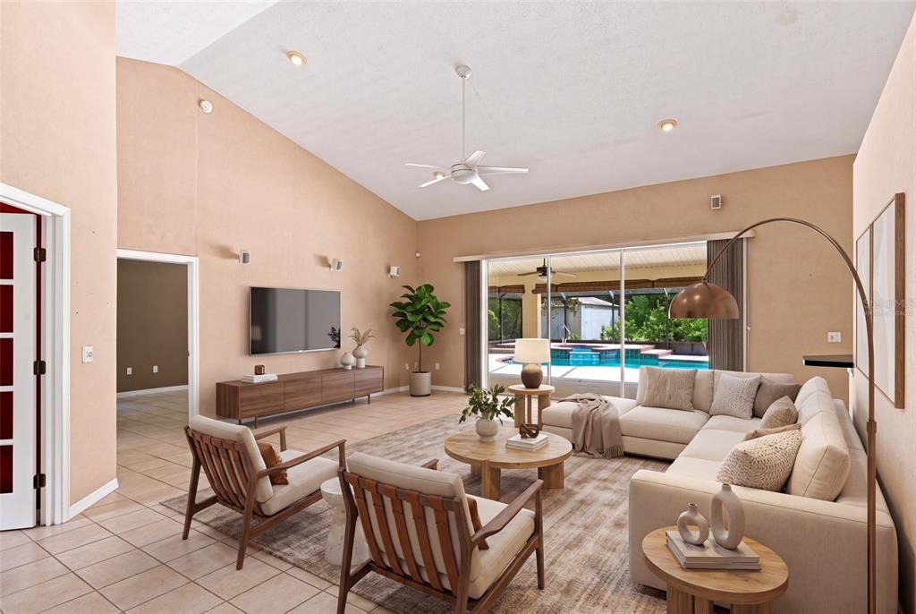 A living room with a vaulted ceiling, tile floors, and a view of a swimming pool — 5928 N OAKMONT DRIVE, BEVERLY HILLS, FL