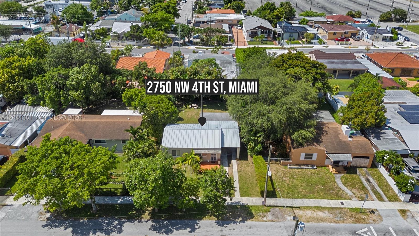 An aerial view shows a single-story house with a metal roof surrounded by trees — 2750 NW 4th St, Miami FL 33125, MIAMI, FL