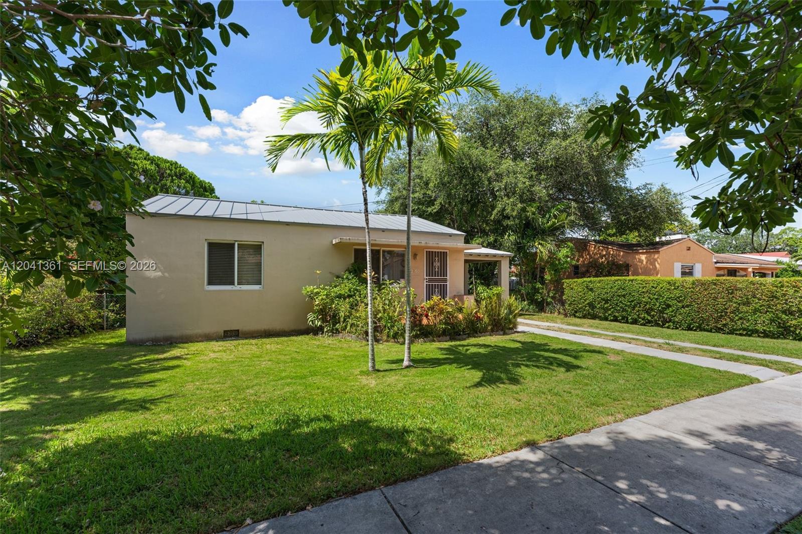 A single-story house with a metal roof, palm trees, and a front lawn — 2750 NW 4th St, Miami FL 33125, MIAMI, FL