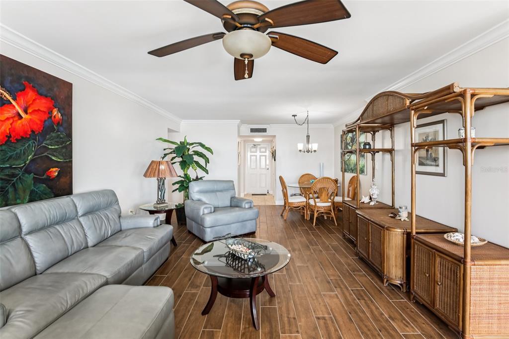 A living and dining area features tile flooring, a ceiling fan, and rattan furniture — 5108 BRITTANY DRIVE S UNIT 805, ST PETERSBURG, FL