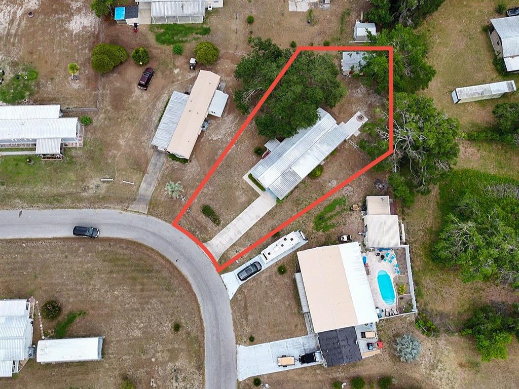 An aerial view shows a mobile home on a lot outlined in red — 10113 SE 24TH DRIVE, WEBSTER, FL