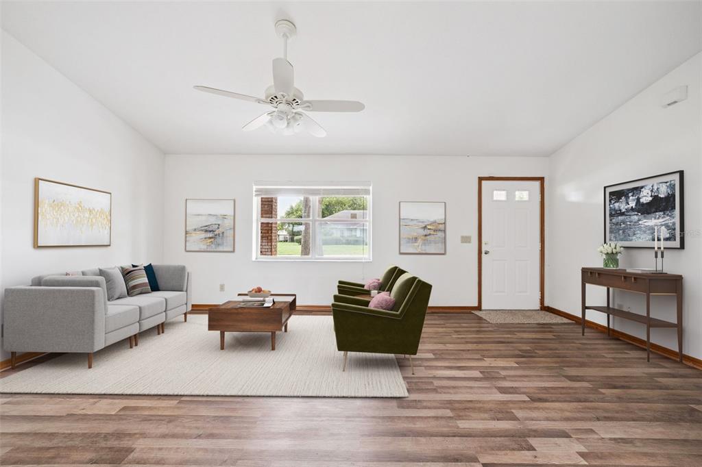 An empty room with white walls, vaulted ceilings, and wood-look flooring — 261 SE 61ST COURT, OCALA, FL